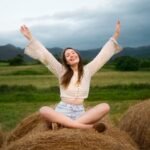 full-shot-smiley-woman-posing-outdoors_23-2149615150