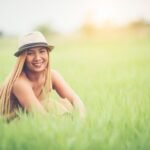 young-woman-sitting-feel-good-grass-field_1150-4313