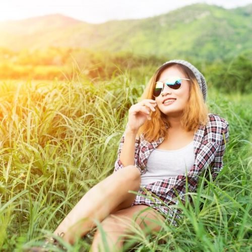 beautiful-hipster-woman-sitting-meadow-with-nature-moun_1150-806